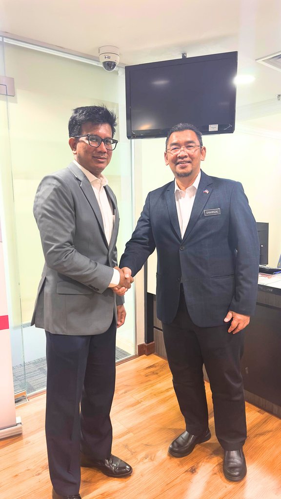 Two representatives shaking hands following a meeting