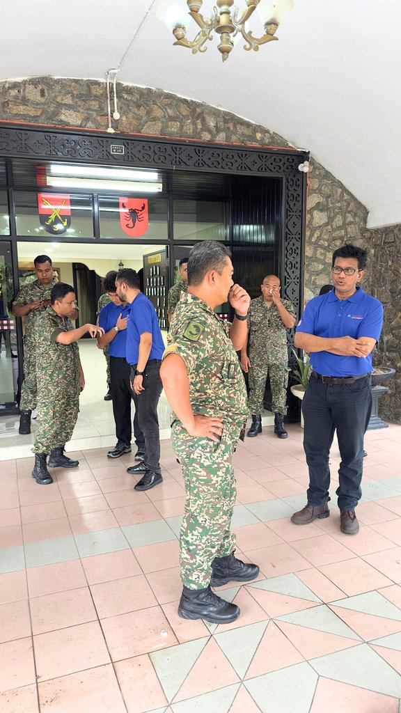 Site visit with uniformed personnel at a facility entrance